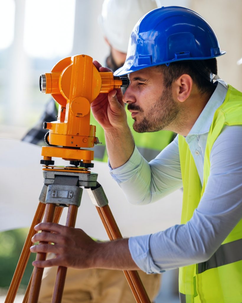 engineer-surveyor-working-with-theodolite-at-construction-site-1.jpg